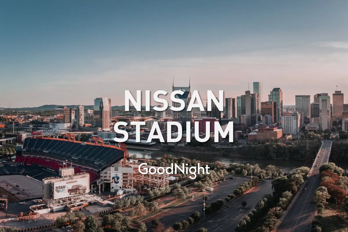 A broad exterior shot of Nissan Stadium with the Nashville city skyline and river in view. The stadium stands as a centerpiece for major sporting events and concerts, while the surrounding cityscape highlights the property's proximity to downtown excitement.